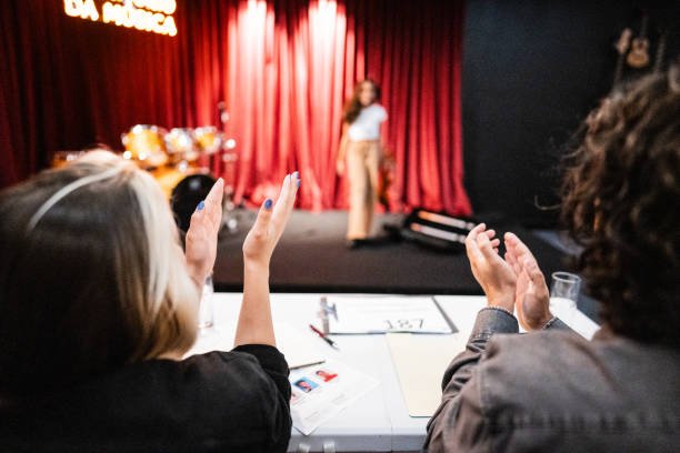 Judges clapping to a contestant in a music contest