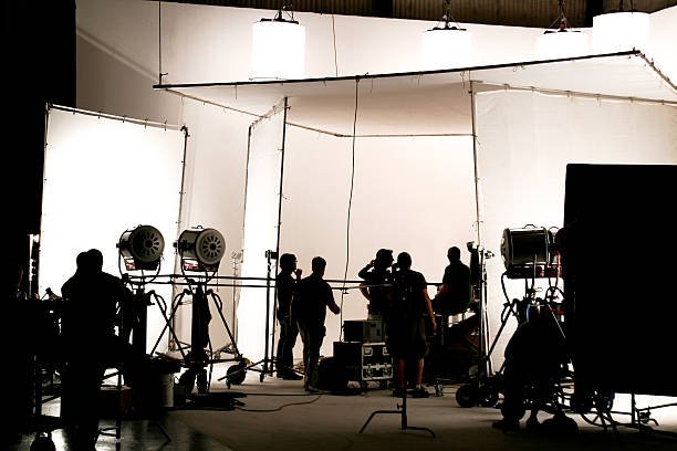 Silhouette of a production in progress on a white stage