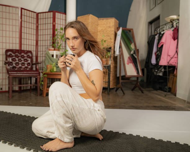A young female yoga practitioner sits in a DTLA studio