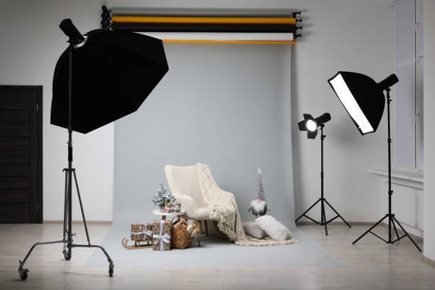 Stylish photo zone with armchair and Christmas decor in professional studio